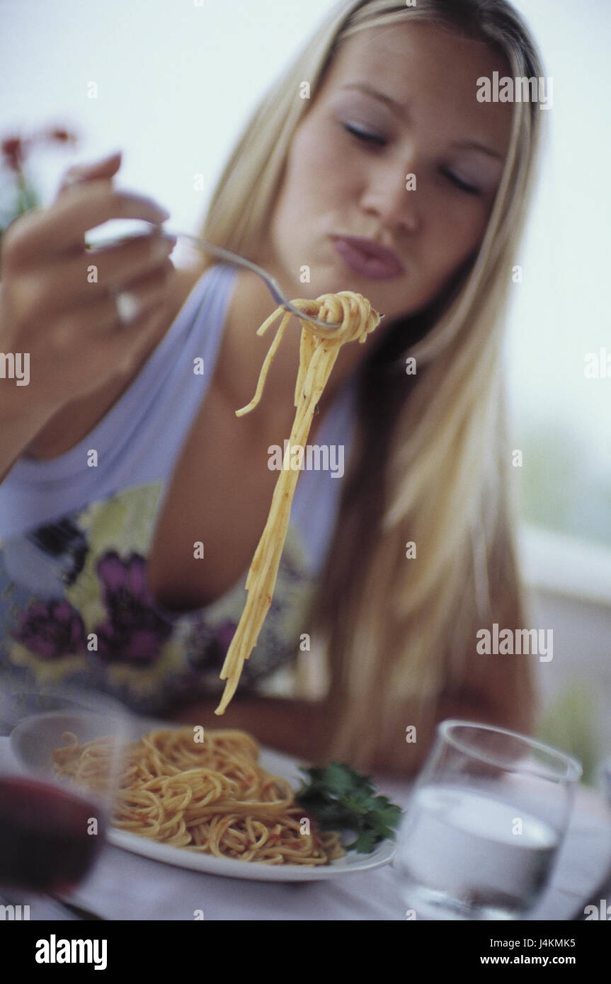 Restaurant, woman, spaghetti, eat, glasses, drinks, portrait, blur outside, bar, terrace, young, happily, smile, enjoy facial play, expression, consumption, food, dish, pasta dish, noodles, in Italian, wine, red wine, water, mineral water, leisure time, lifestyle Stock Photo