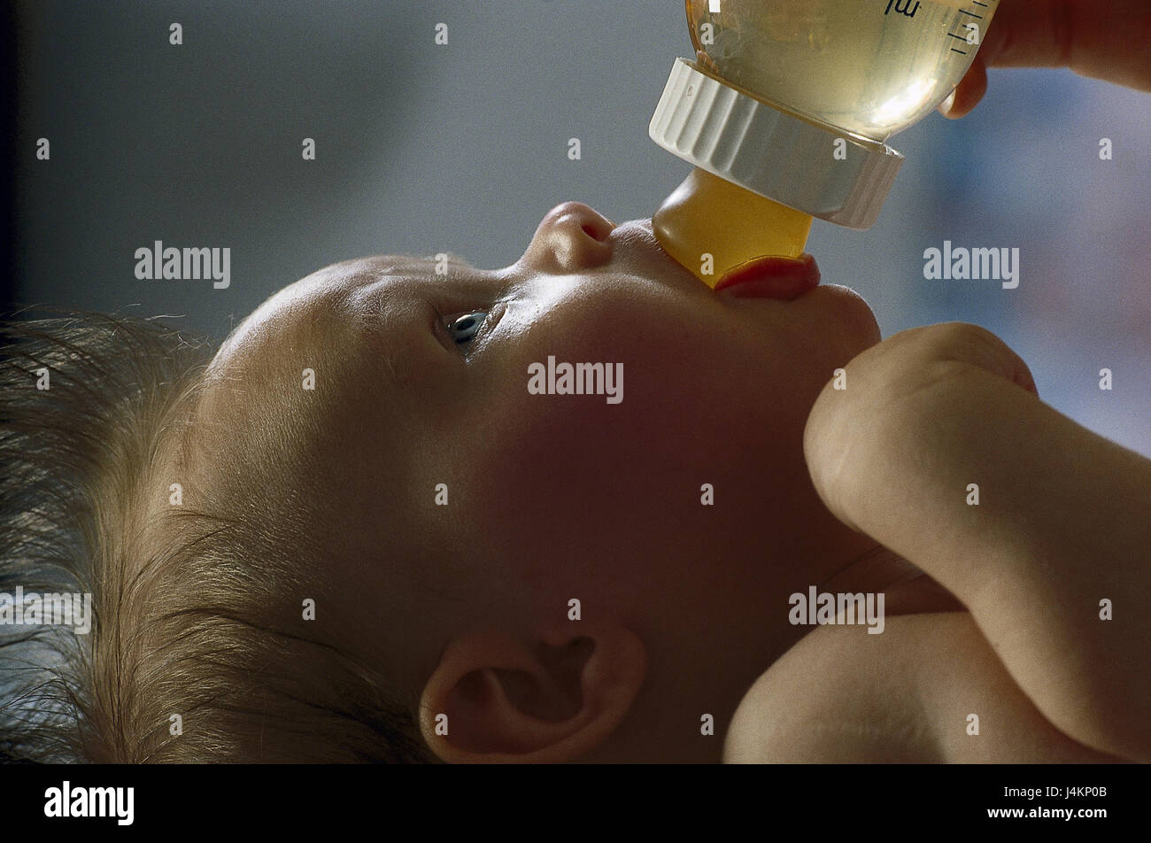 Baby, baby's bottle, portrait inside, at home, child, lie, drink hunger