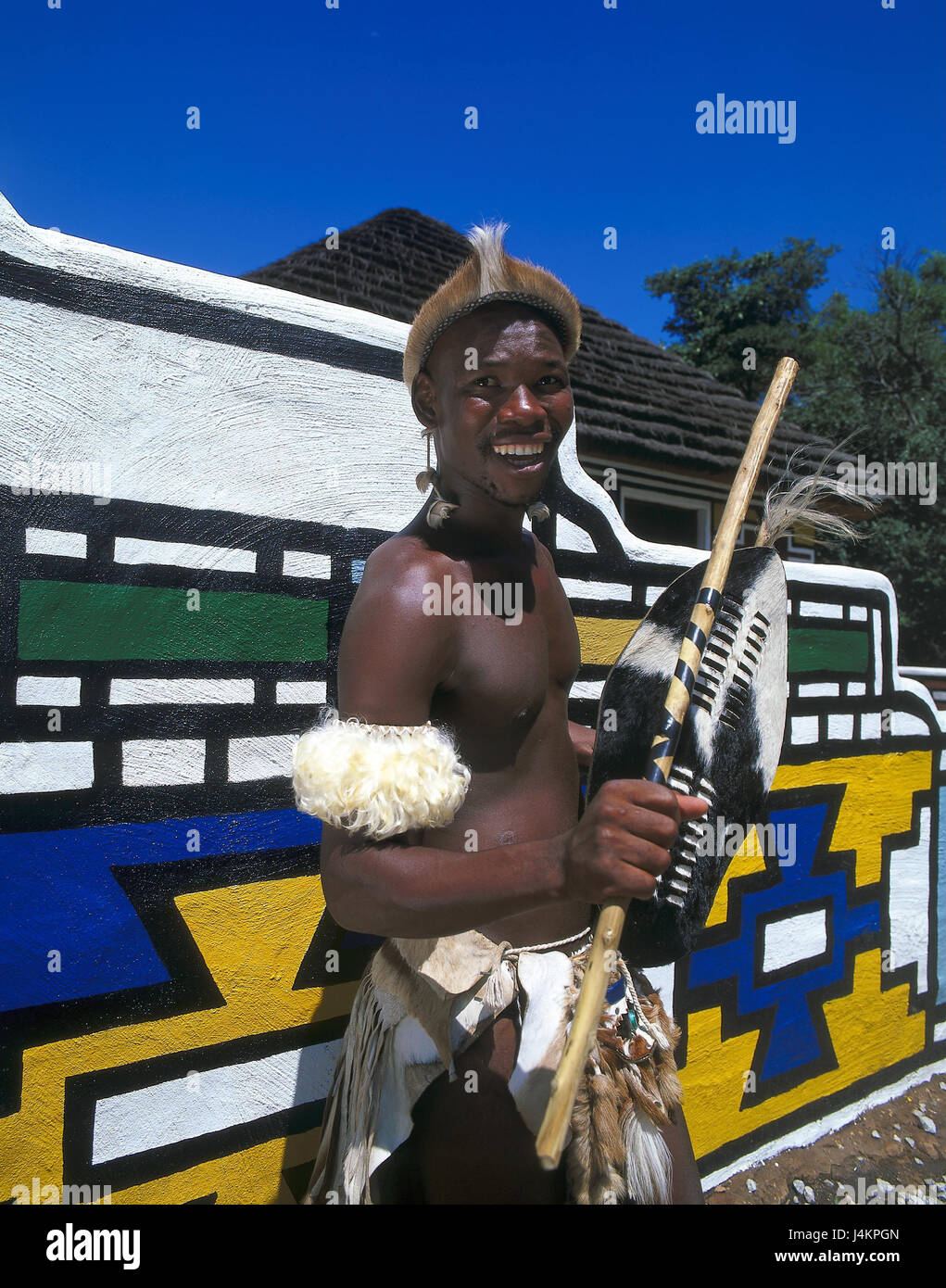 South Africa, Lesedi, defensive wall, paints, Zulu's warriors, half portrait no model release Africa, close Johannesburg, tribe, Zulu tribe, local, non-white, African, warrior, headgear, loincloth, laugh, happily, tradition, folklore, tourist attraction Stock Photo
