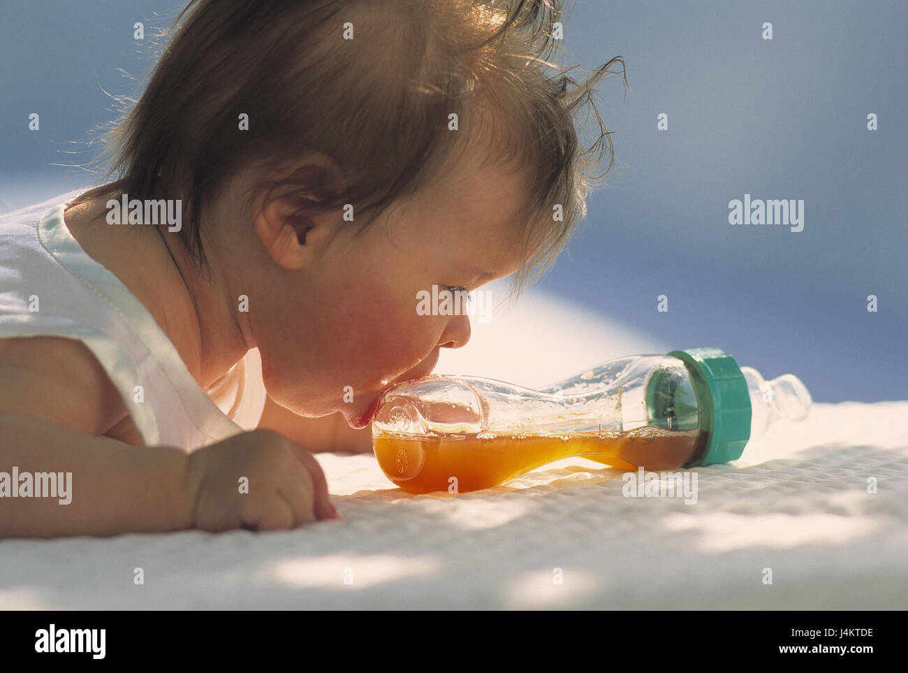 Baby, lie, baby's bottle, drinking attempt, portrait, at the side outside, summer, child, infant, abdominal position, clumsy, mouth, flask, drinking flask Stock Photo