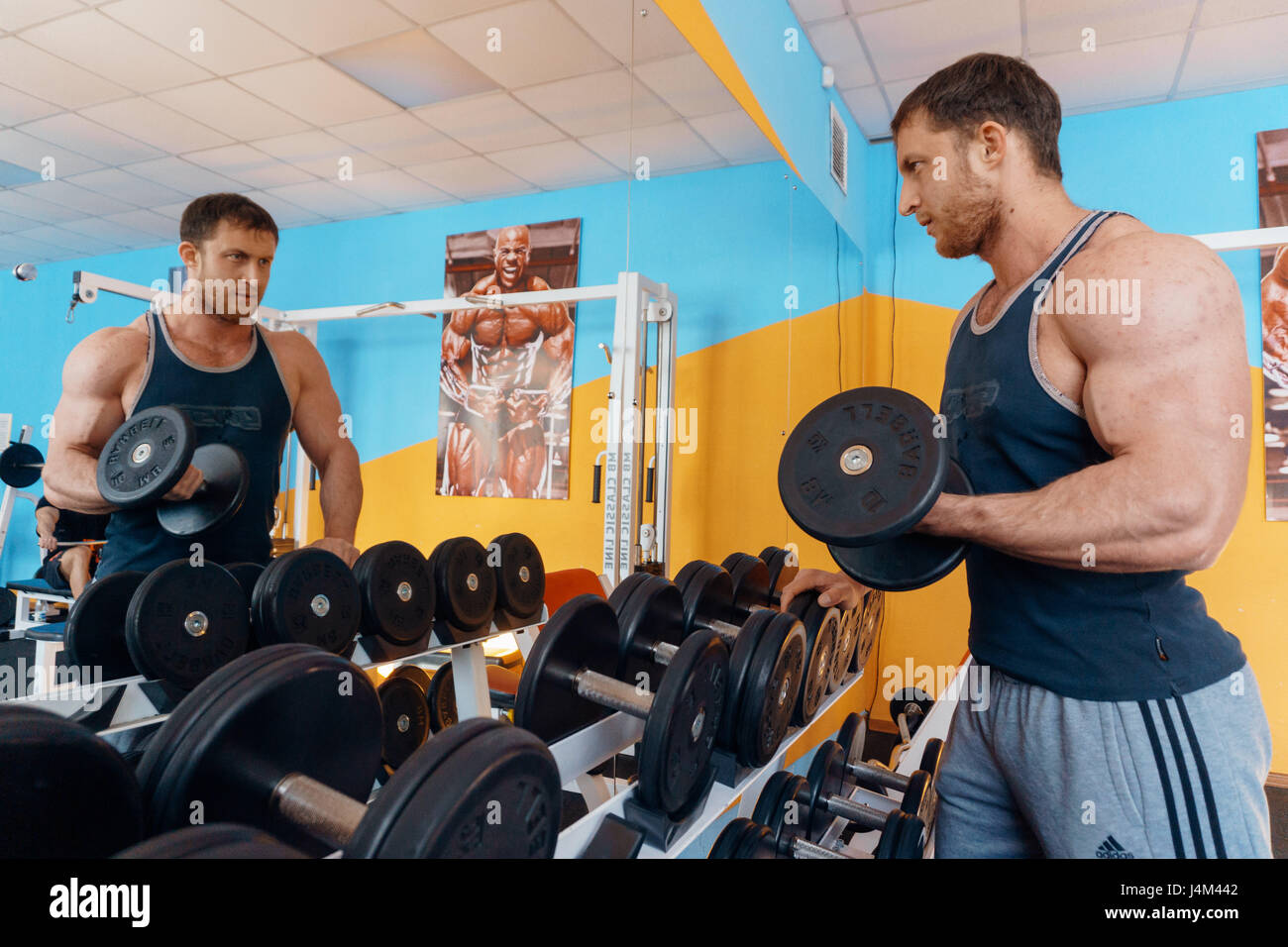 A Big Handsome Strong Male Bodybuilder Doing A Bench Press In The