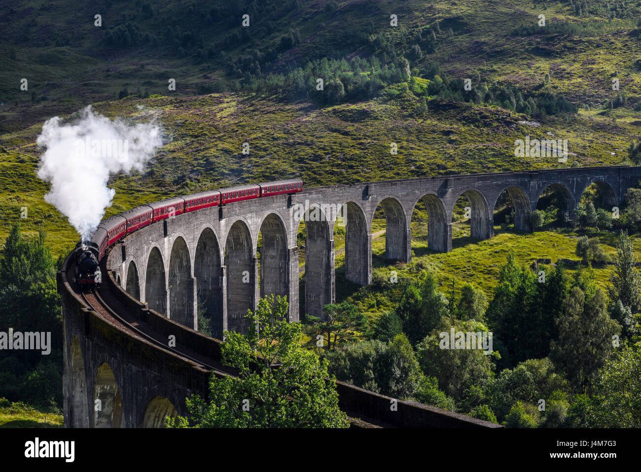 Jacobite steam train on Glenfinnan Viaduct. Highlands, Scotland, United Kingdom Stock Photo