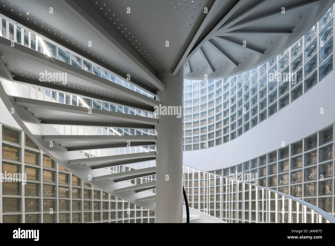 Helical staircase and glass brick facade. Housing Building, Quai Henri IV, Paris, France. Architect: LIN, 2015. Stock Photo