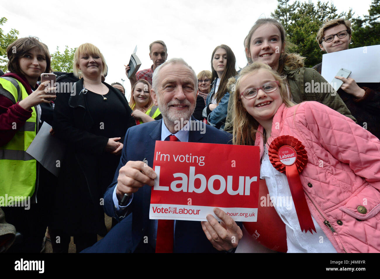 Labour leader Jeremy Corbyn with local supporters Laila Walker, seven, (right) and her sister Grace, ten, (second right) at the James Paget Hospital in Gorleston-on-Sea, Great Yarmouth, during the campaign trail. Stock Photo