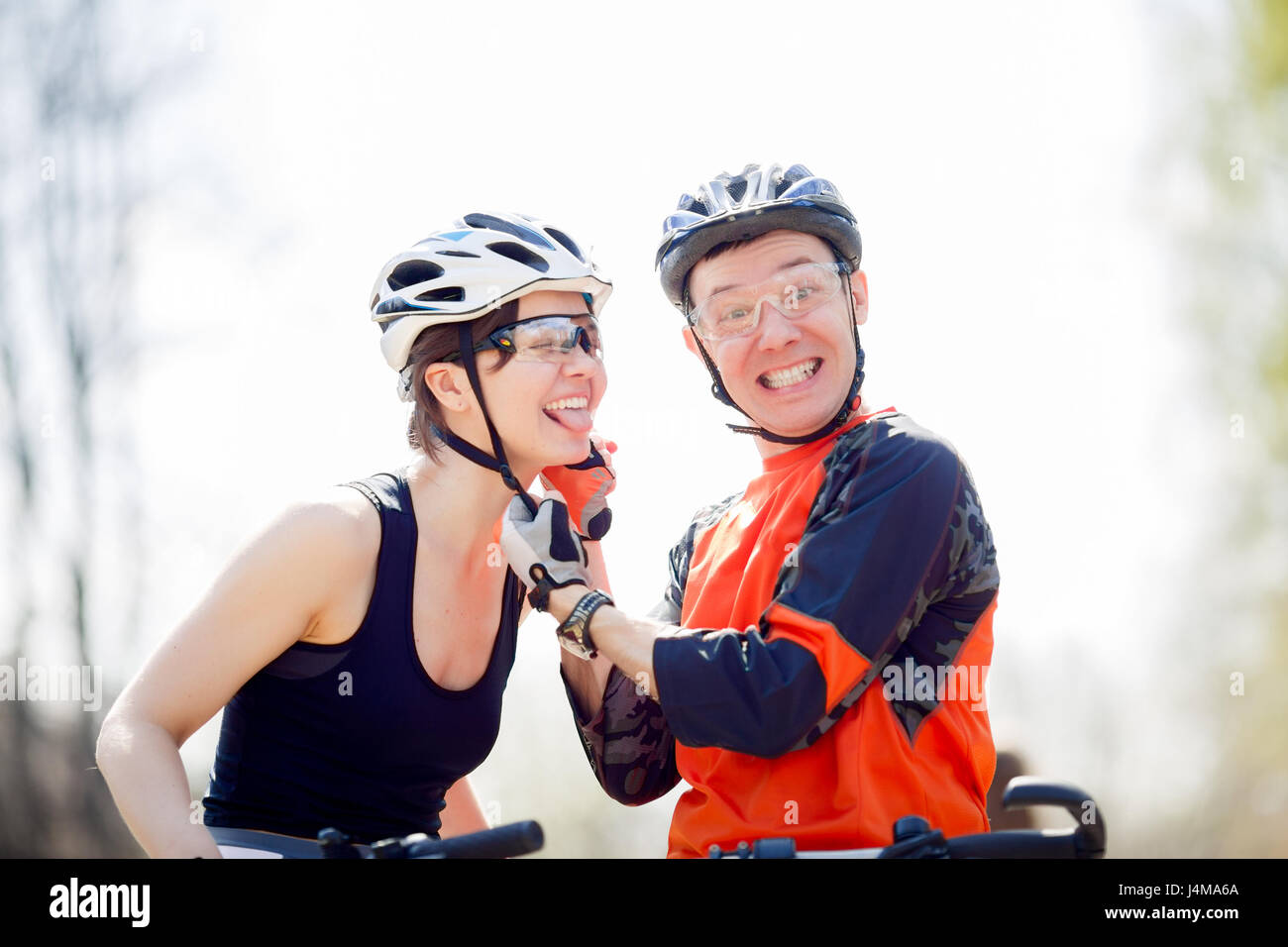 Bicyclists wear helmets in park Stock Photo