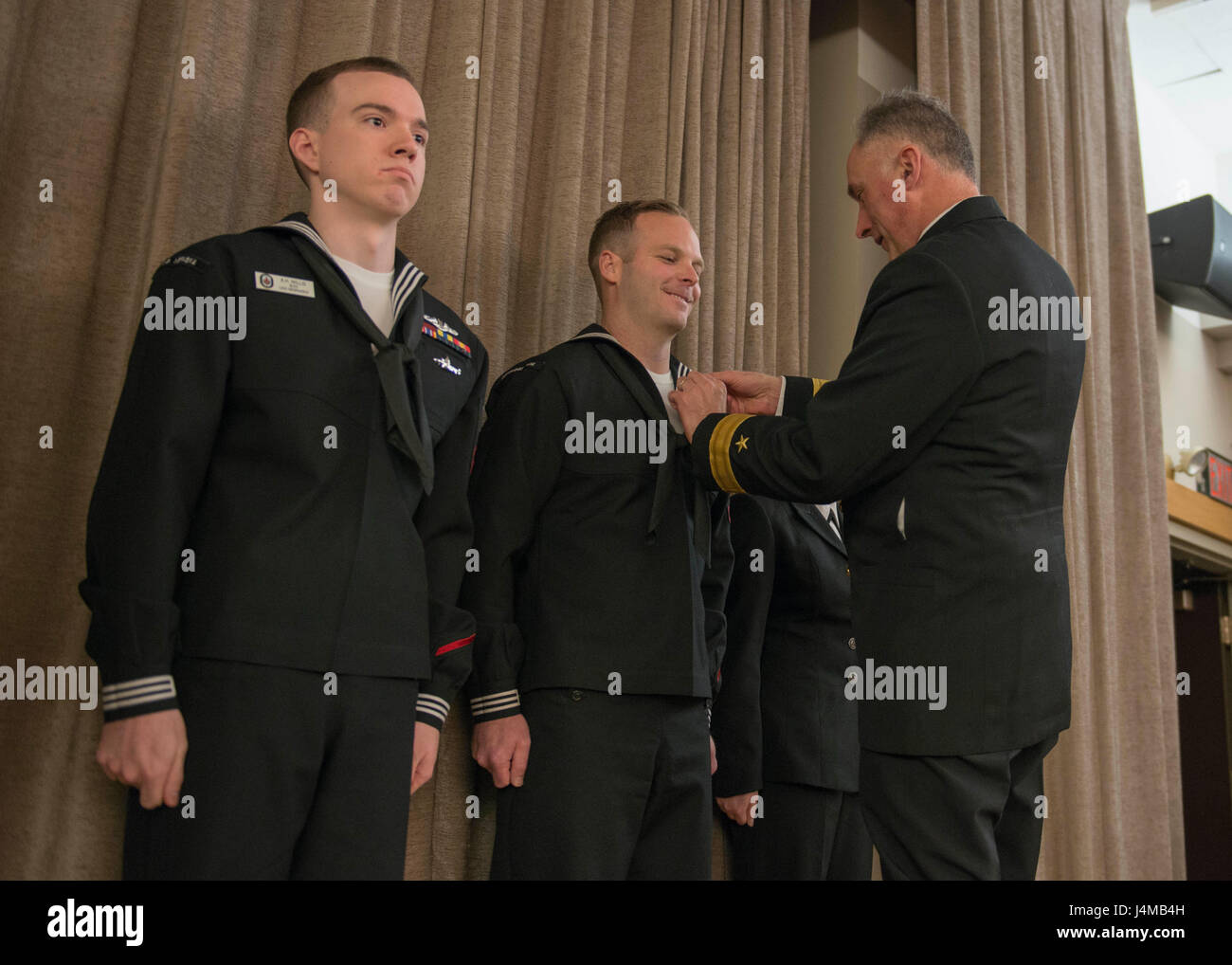 BANGOR, Wash. (Jan. 17, 2017) Rear Adm. John Tammen, commander, Submarine Group 9, congratulates Culinary Specialist 2nd Class Bradley White, from Cincinnati, Ohio, assigned to Submarine Group 9, on becoming the 2016 Shore Junior Sailor of the Year. The Shore Sailor of the Year Program was introduced in 1973, by former Chief of Naval Operations Adm. Elmo Zumwalt, to recognize superior performance at every command. (U.S. Navy photo by Mass Communication Specialist 1st Class Amanda R. Gray/Released) Stock Photo
