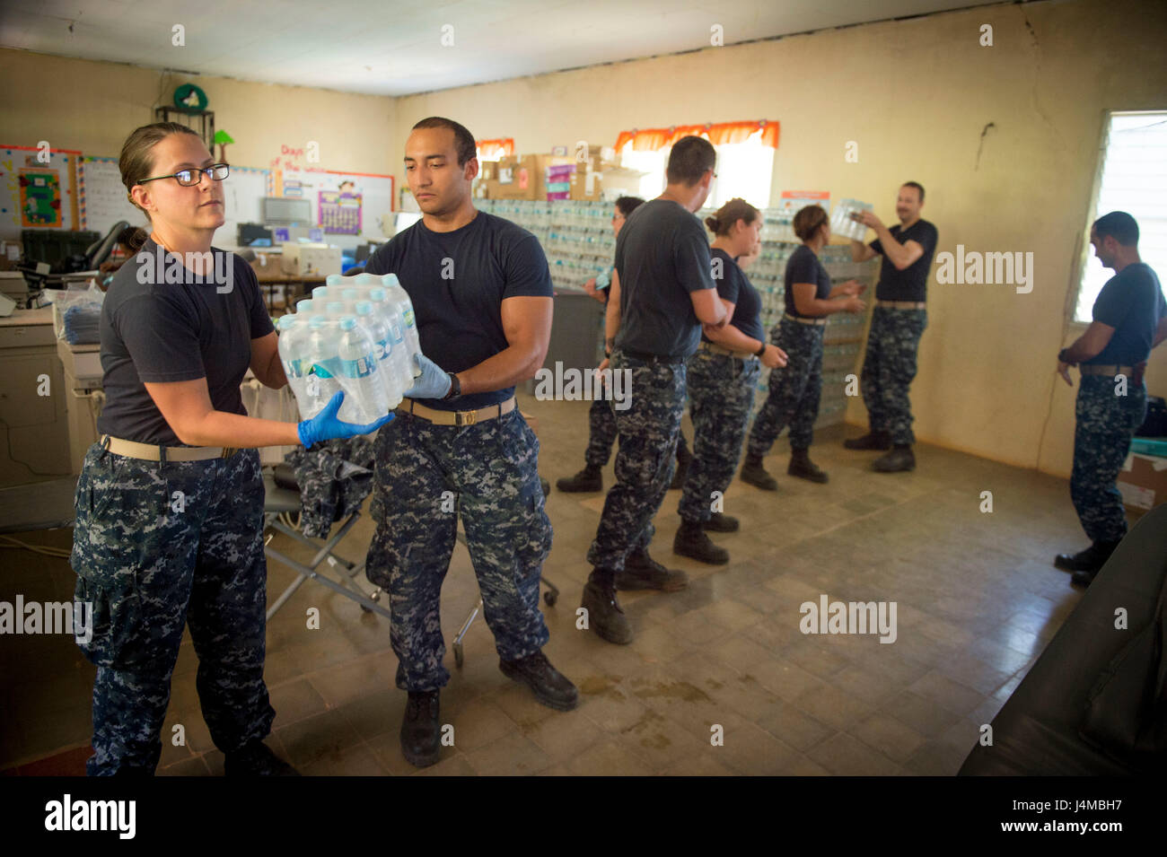 170220-N-YL073-221 TRUJILLO, Honduras (Feb. 20, 2017) – Sailors pass drinking water at the Continuing Promise 2017 (CP-17) medical site in support of CP-17's visit to Trujillo, Honduras. CP-17 is a U.S. Southern Command-sponsored and U.S. Naval Forces Southern Command/U.S. 4th Fleet-conducted deployment to conduct civil-military operations including humanitarian assistance, training engagements, and medical, dental, and veterinary support in an effort to show U.S. support and commitment to Central and South America. (U.S. Navy photo by Mass Communication Specialist 2nd Class Shamira Purifoy) Stock Photo