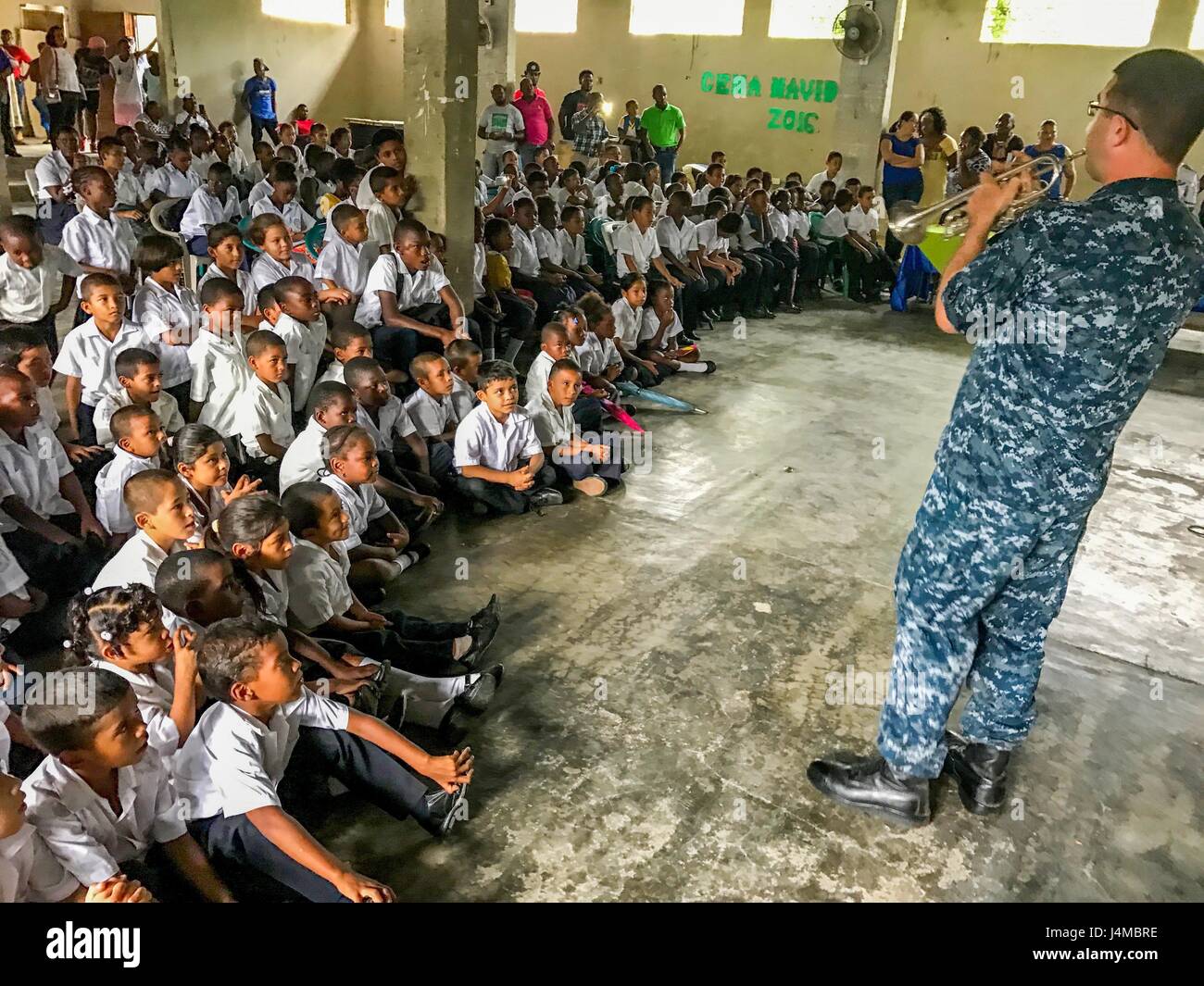 170222-N-YL073-002 SANTA FE, Honduras (Feb. 22, 2017) – Musician 2nd Class Matthew Kinnaman, a native of Phoenix assigned to the U.S. Fleet Forces (USFF) Band, Norfolk, Va., plays the trumpet for host nation school children in support of Continuing Promise 2017’s (CP-17) visit to Trujillo, Honduras. CP-17 is a U.S. Southern Command-sponsored and U.S. Naval Forces Southern Command/U.S. 4th Fleet-conducted deployment to conduct civil-military operations including humanitarian assistance, training engagements, and medical, dental, and veterinary support in an effort to show U.S. support and commi Stock Photo