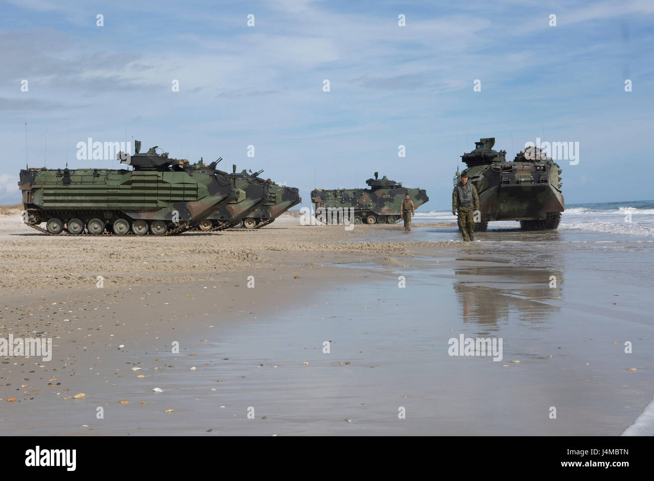 U.S. Marines with 2nd Platoon, Alpha Company, 2nd Assault Amphibian Battalion, 2nd Marine Division (2d MARDIV), ground-guide AAV-P7/A1 assault amphibious vehicles at Onslow Beach, Camp Lejeune, N.C., Feb. 22, 2017. Marines conducted amphibious assaults to enhance and maintain proficiency on ship to shore movement. (U.S. Marine Corps photo by Lance Cpl. Alexis C. Schneider) Stock Photo