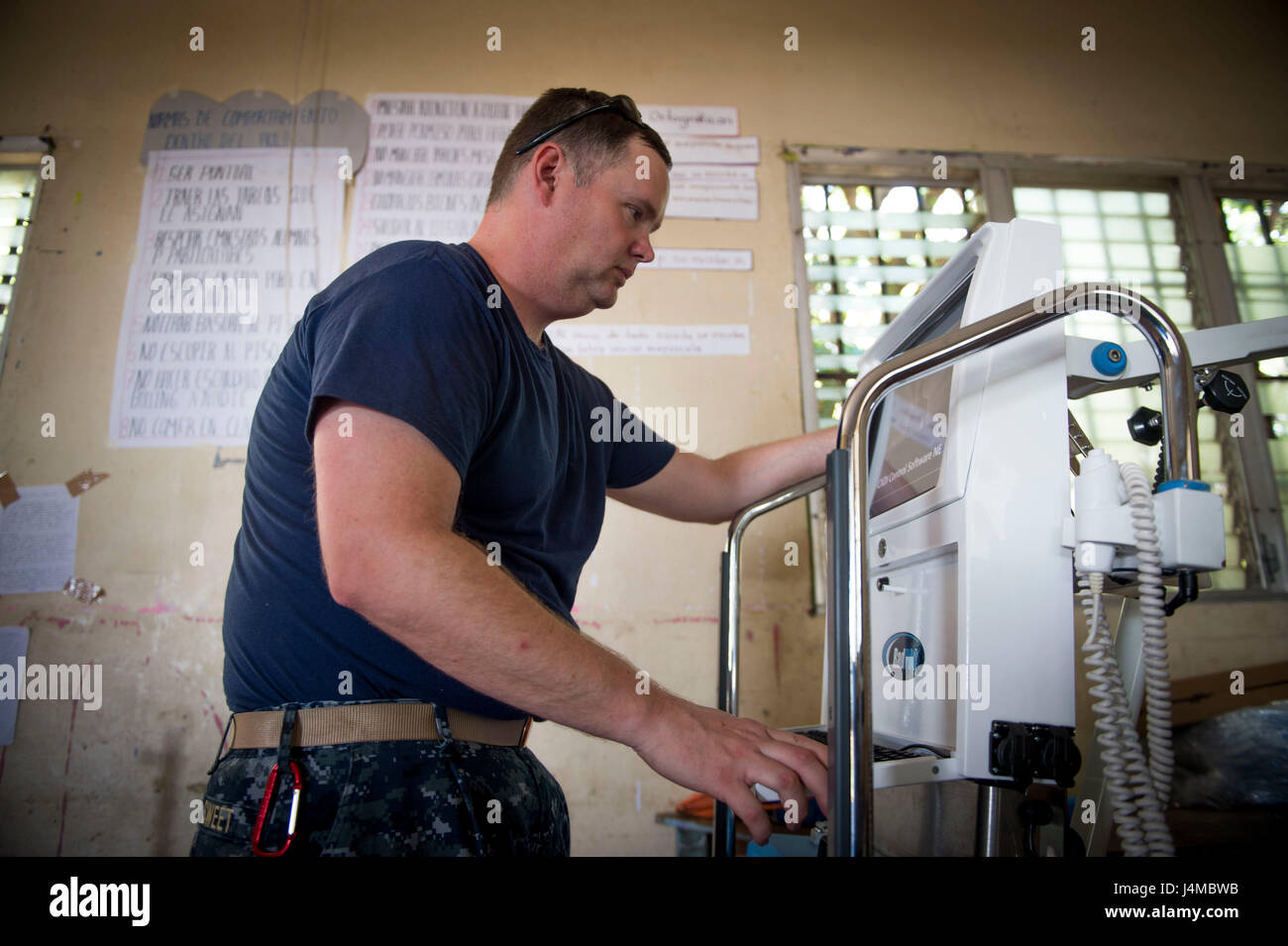 170220-N-YL073-109 TRUJILLO, Honduras (Feb. 20, 2017) – Lt. Cmdr. Nicholas Sweet, a native of Grenada, Miss., assigned to Naval Hospital Camp Lejeune, N.C., configures an X-ray machine at the Continuing Promise 2017 (CP-17) medical site in support of CP-17's visit to Trujillo, Honduras. CP-17 is a U.S. Southern Command-sponsored and U.S. Naval Forces Southern Command/U.S. 4th Fleet-conducted deployment to conduct civil-military operations including humanitarian assistance, training engagements, and medical, dental, and veterinary support in an effort to show U.S. support and commitment to Cent Stock Photo