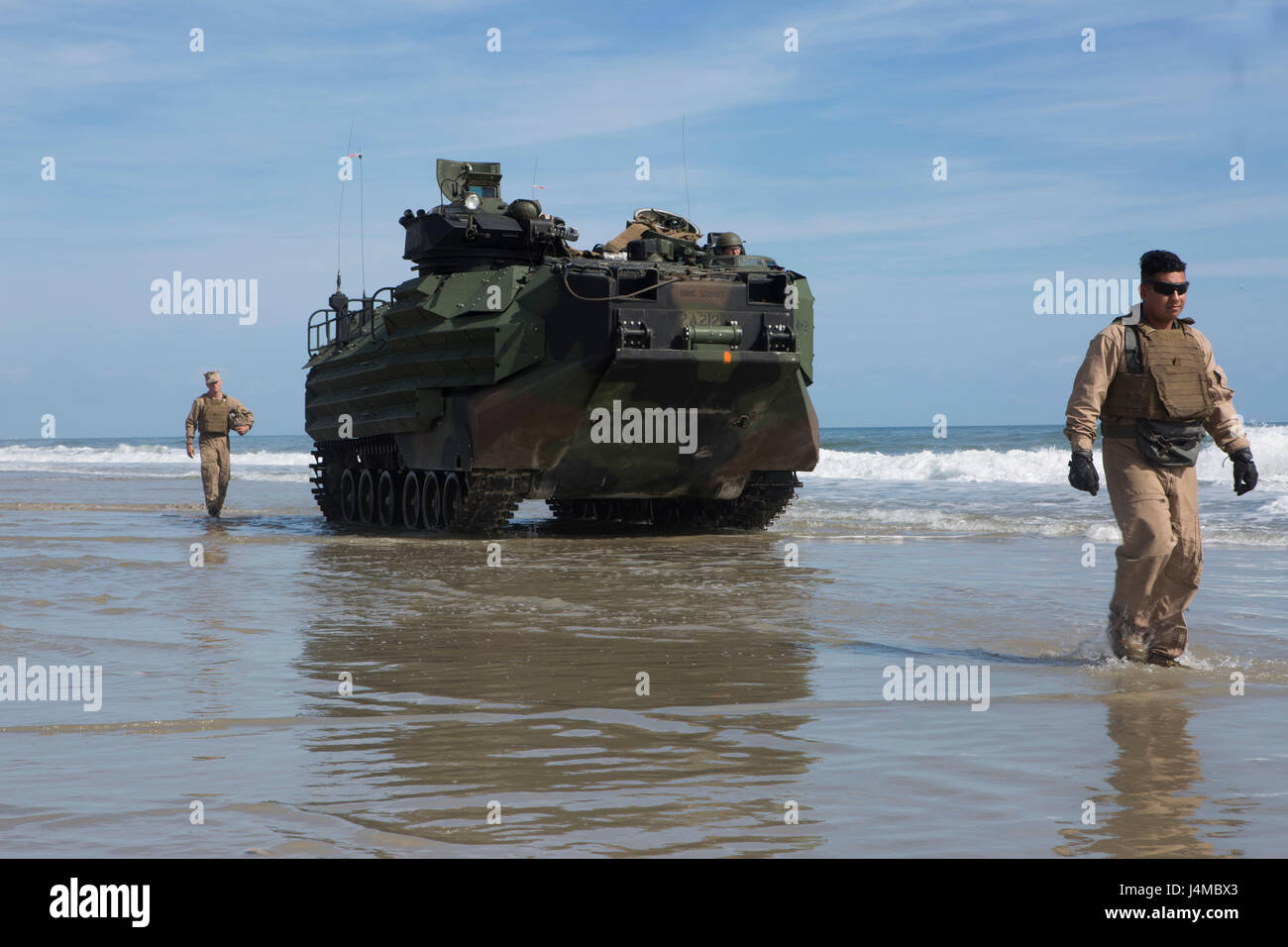 U.S. Marines with 2nd Platoon, Alpha Company, 2nd Assault Amphibian Battalion, 2nd Marine Division (2d MARDIV), ground-guide an AAV-P7/A1 assault amphibious vehicle at Onslow Beach, Camp Lejeune, N.C., Feb. 22, 2017. Marines conducted amphibious assaults to enhance and maintain proficiency on ship to shore movement. (U.S. Marine Corps photo by Lance Cpl. Alexis C. Schneider) Stock Photo