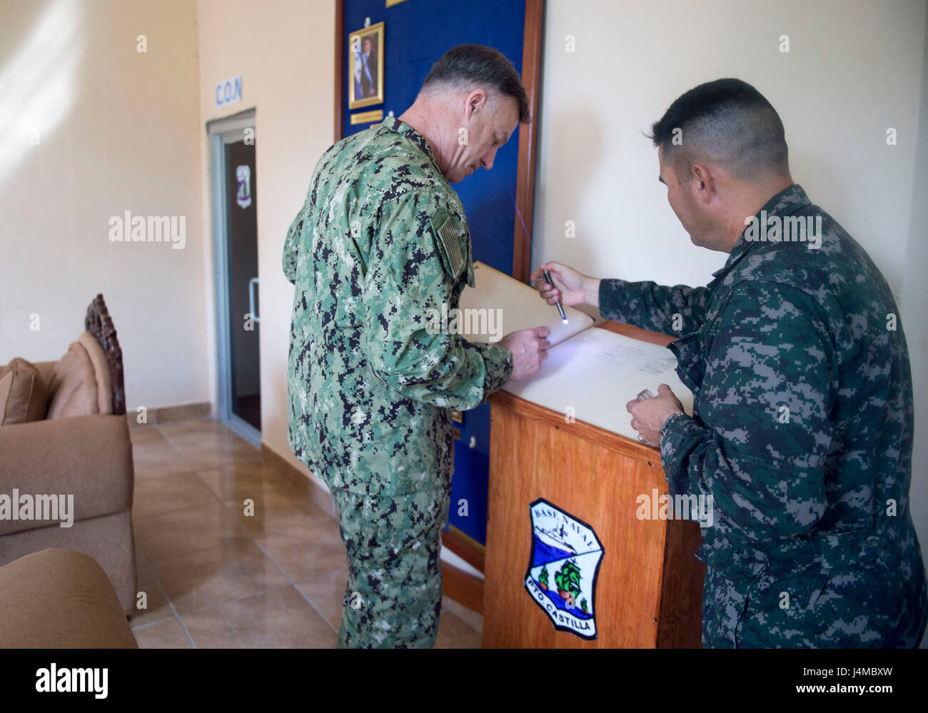 170223-N-YL073-074 TRUJILLO, Honduras (Feb. 23, 2017) – Rear Adm. Sean S. Buck, Commander U.S. Naval Forces Southern Command/U.S. 4th Fleet (USNAVSO/FOURTHFLT), signs the guest book while visiting the commander of Naval Base Puerto Castilla, Honduras, in support of Continuing Promise 2017’s (CP-17) visit to Trujillo, Honduras. CP-17 is a U.S. Southern Command-sponsored and U.S. Naval Forces Southern Command/U.S. 4th Fleet-conducted deployment to conduct civil-military operations including humanitarian assistance, training engagements, and medical, dental, and veterinary support in an effort to Stock Photo
