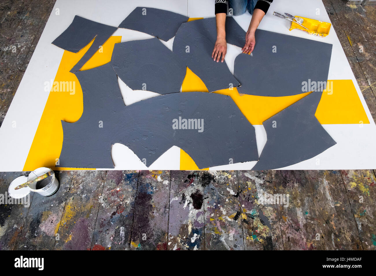 Caucasian artist arranging pieces of painting Stock Photo