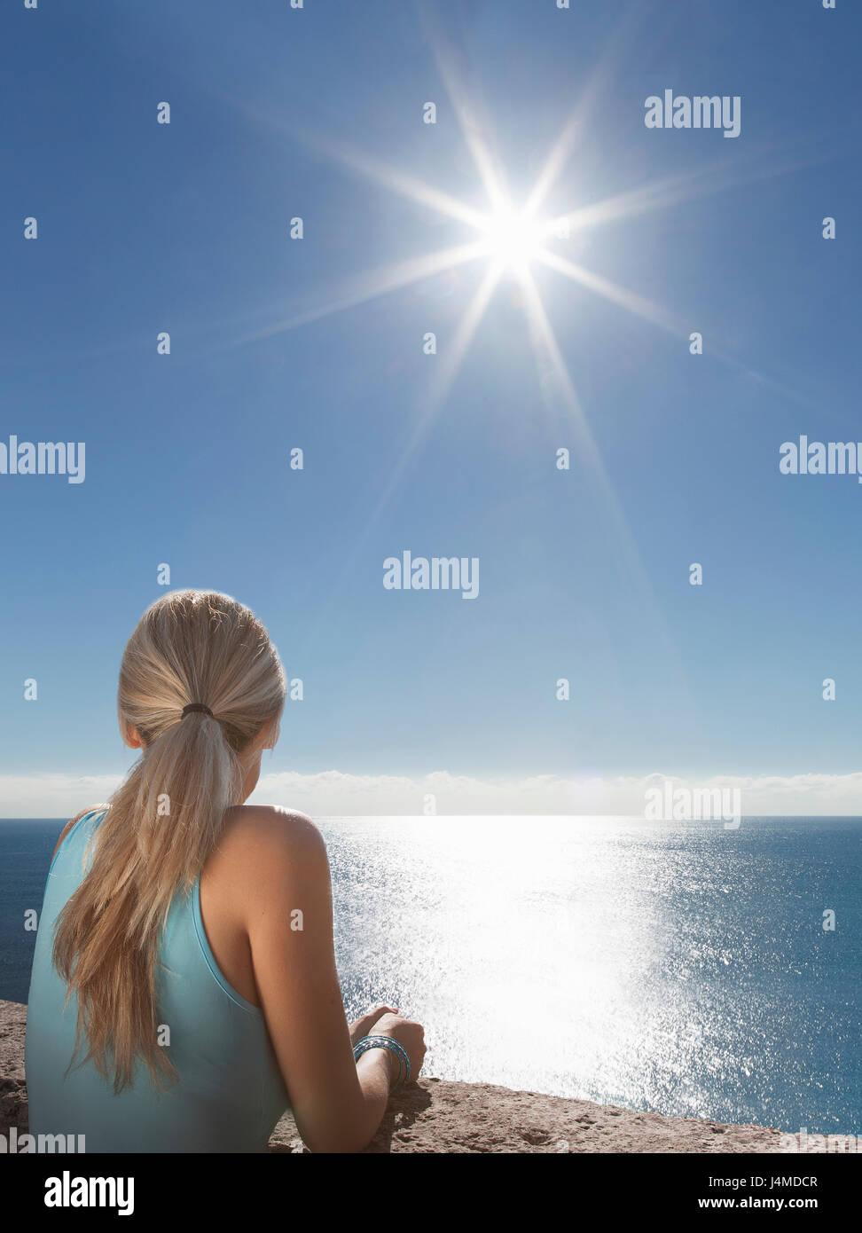 Caucasian woman admiring scenic view of ocean Stock Photo