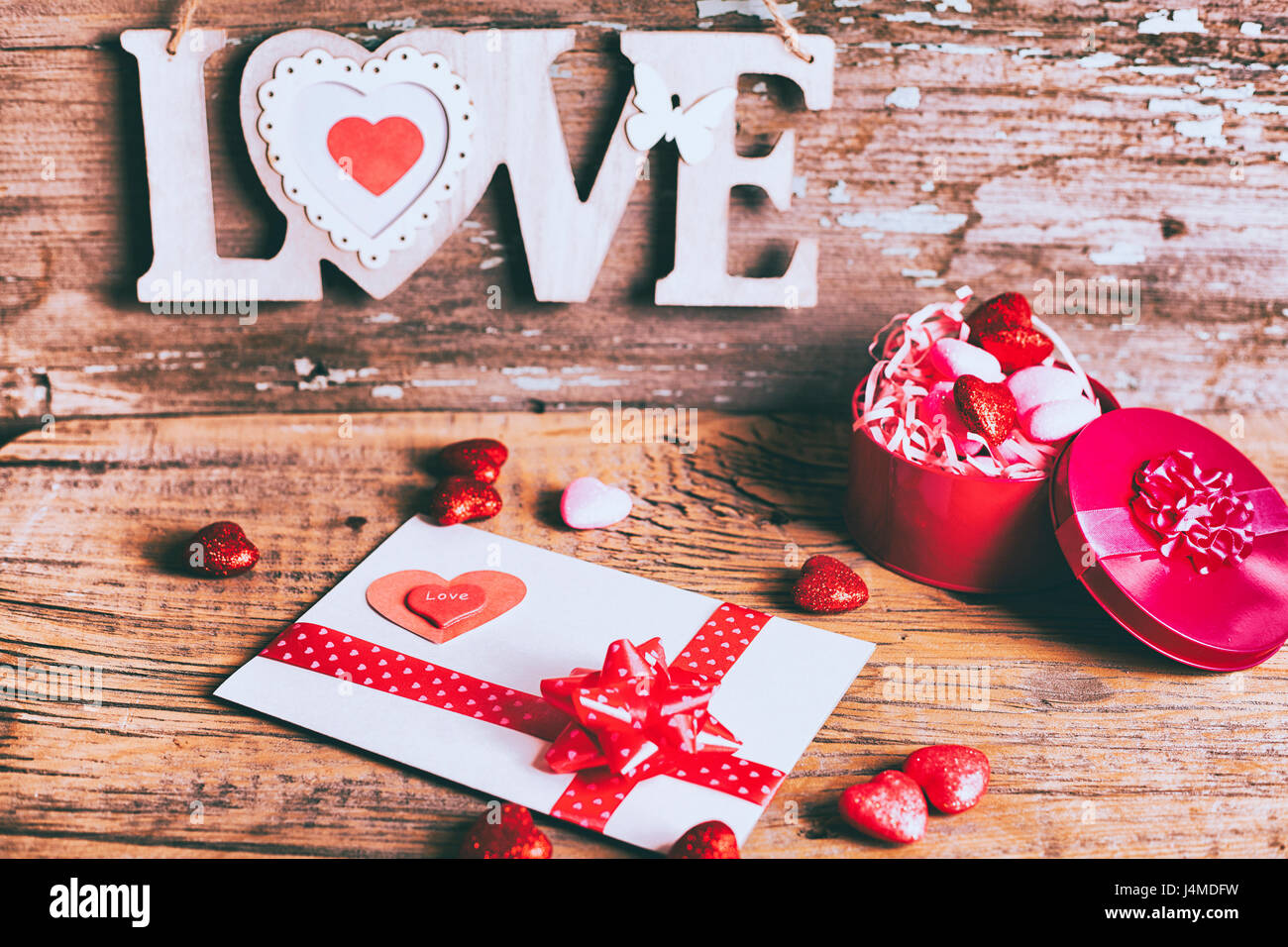 Valentine card and gift box near love carving Stock Photo