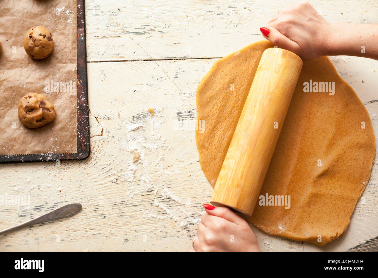 Hands of woman using rolling pin on cookie dough Stock Photo Alamy