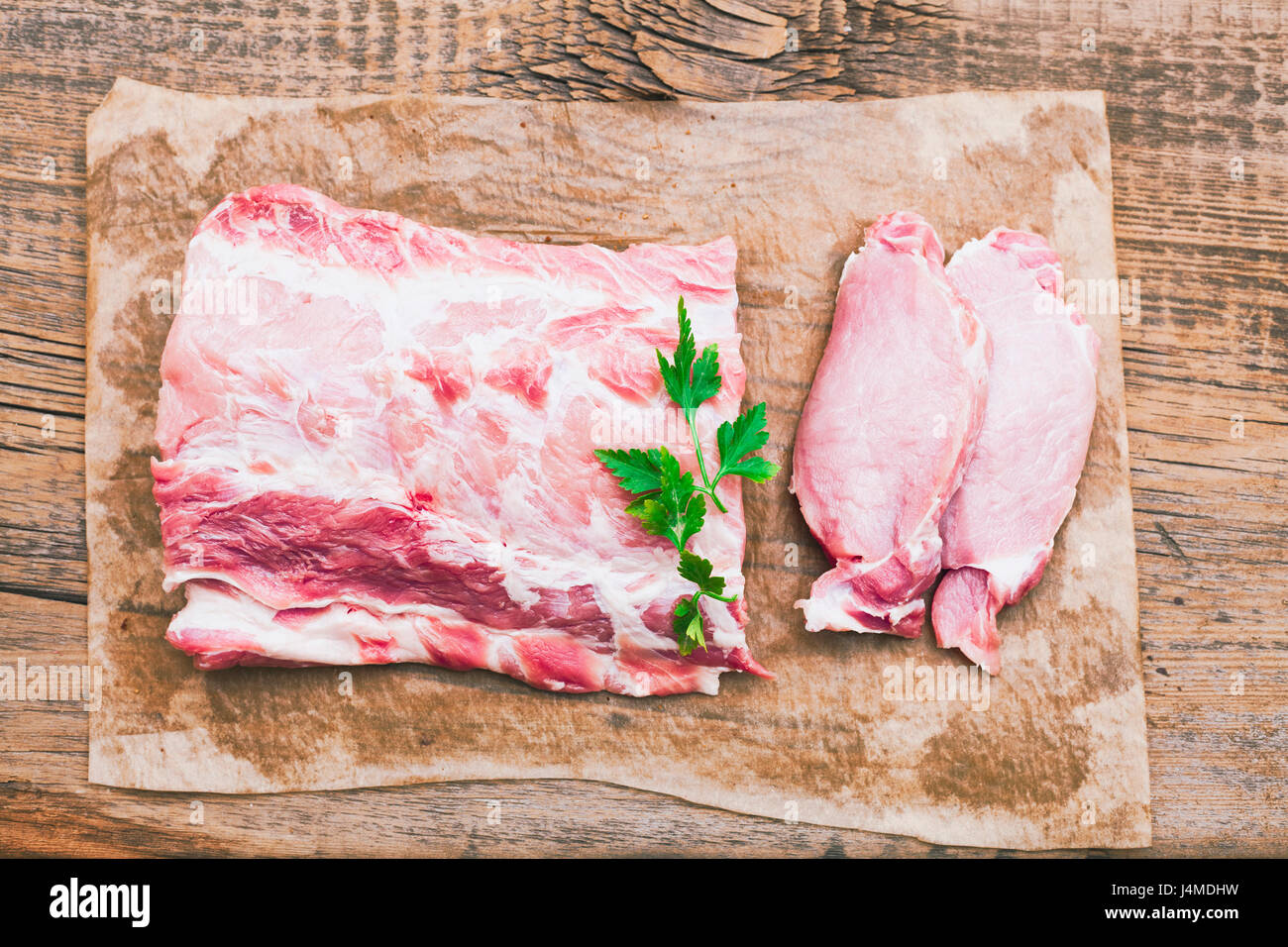 Raw meat and garnish on butcher paper Stock Photo Alamy