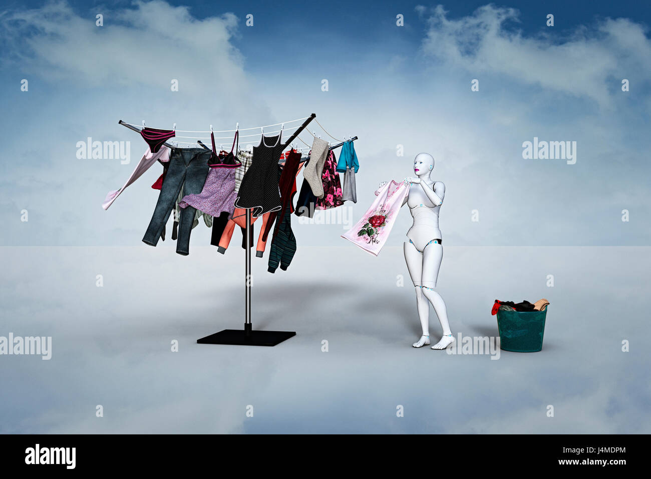 Woman robot hanging laundry on clothesline Stock Photo