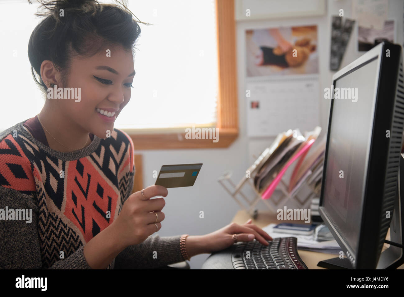 Mixed Race woman online shopping using computer Stock Photo