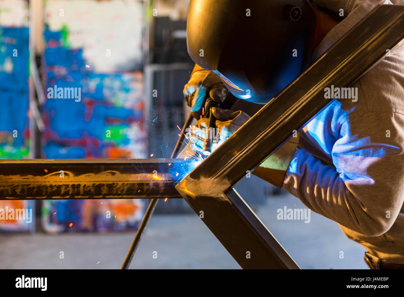 Man welding metal sculpture Stock Photo