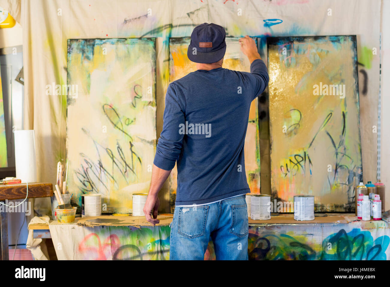Caucasian man creating paintings Stock Photo
