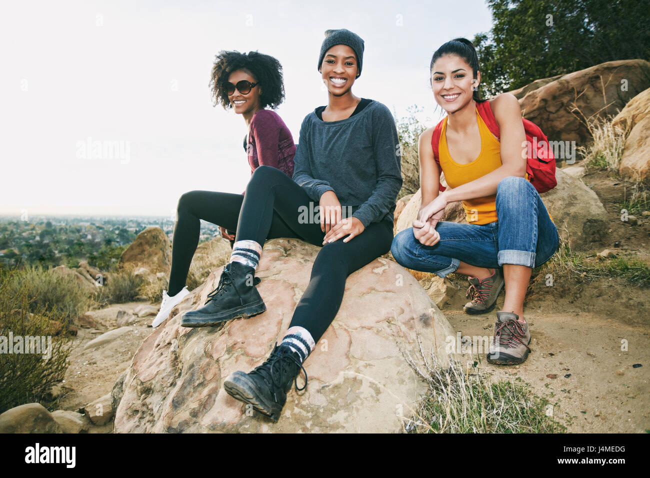 Women sitting on rock hi-res stock photography and images - Alamy