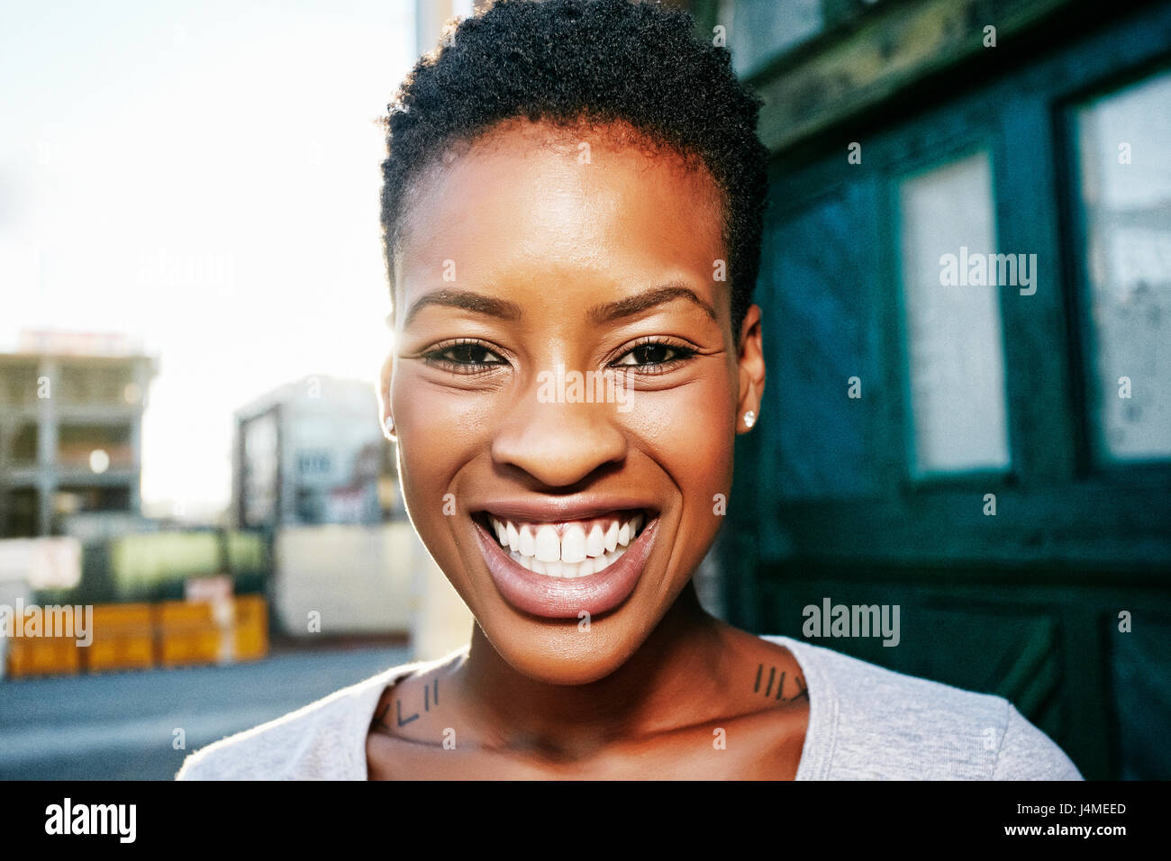 Portrait of smiling Black woman posing in city Stock Photo - Alamy