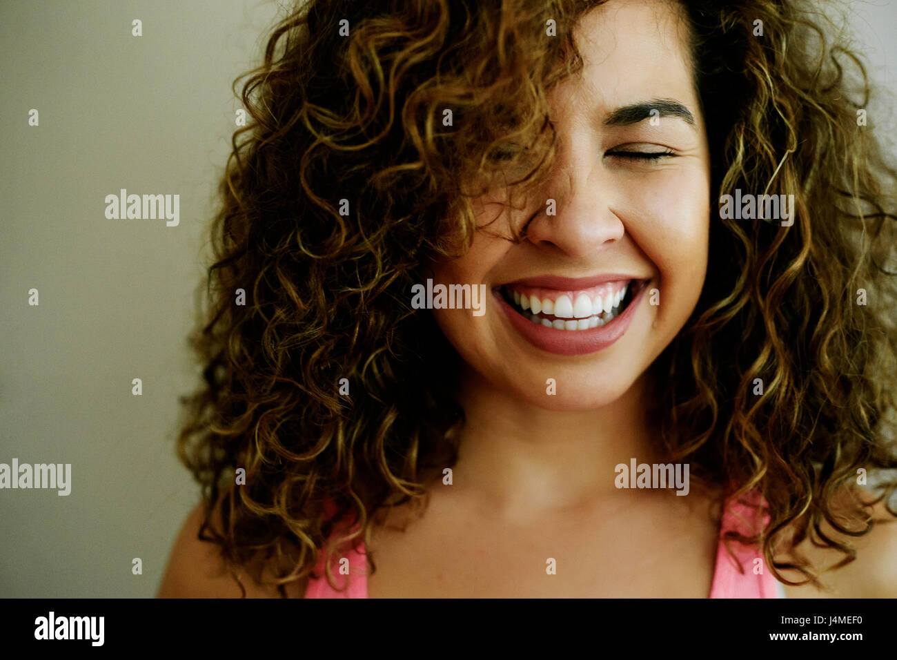 Portrait of laughing Mixed Race woman Stock Photo