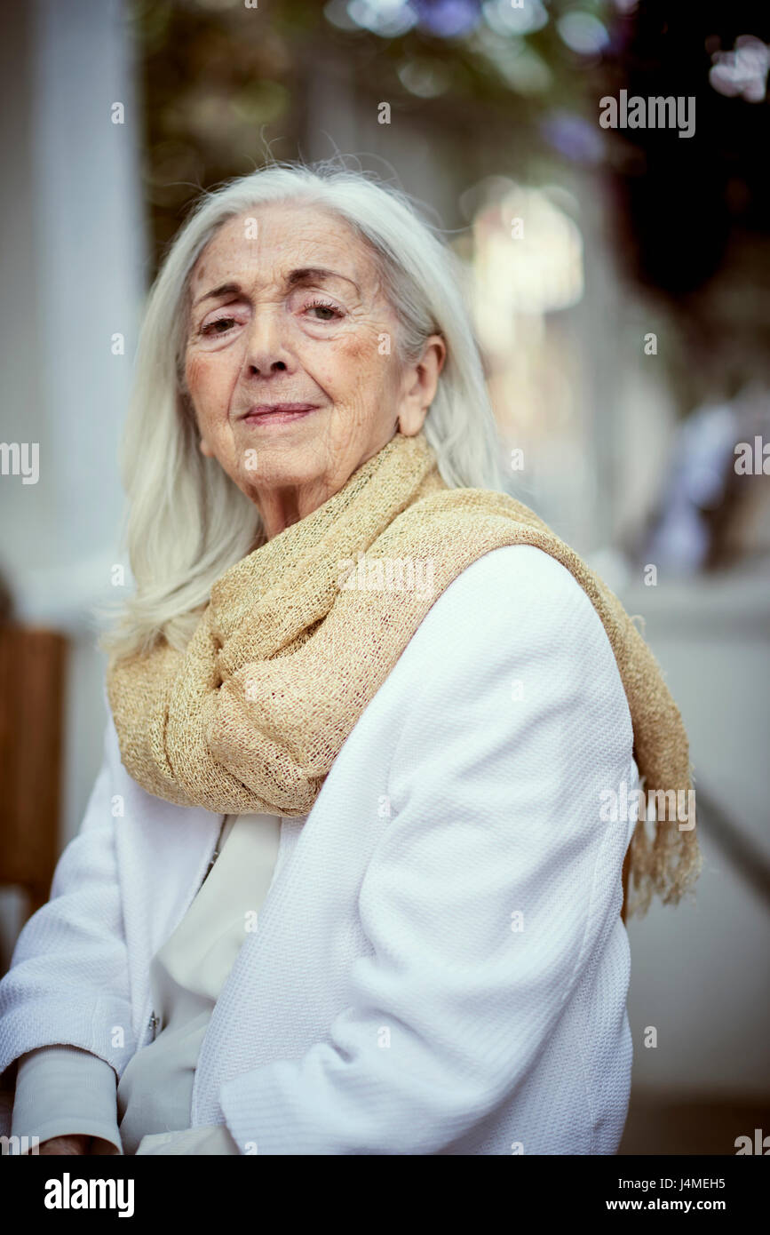 Portrait of serious older Caucasian woman wearing scarf Stock Photo