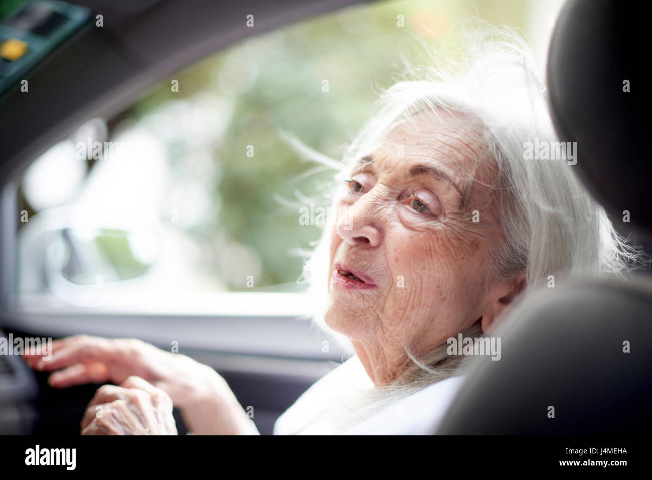 Older Caucasian woman sitting in car Stock Photo