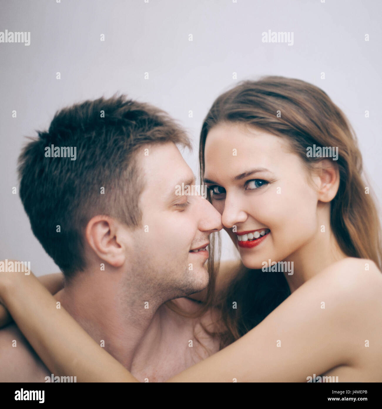 Portrait of cuddling Caucasian couple Stock Photo
