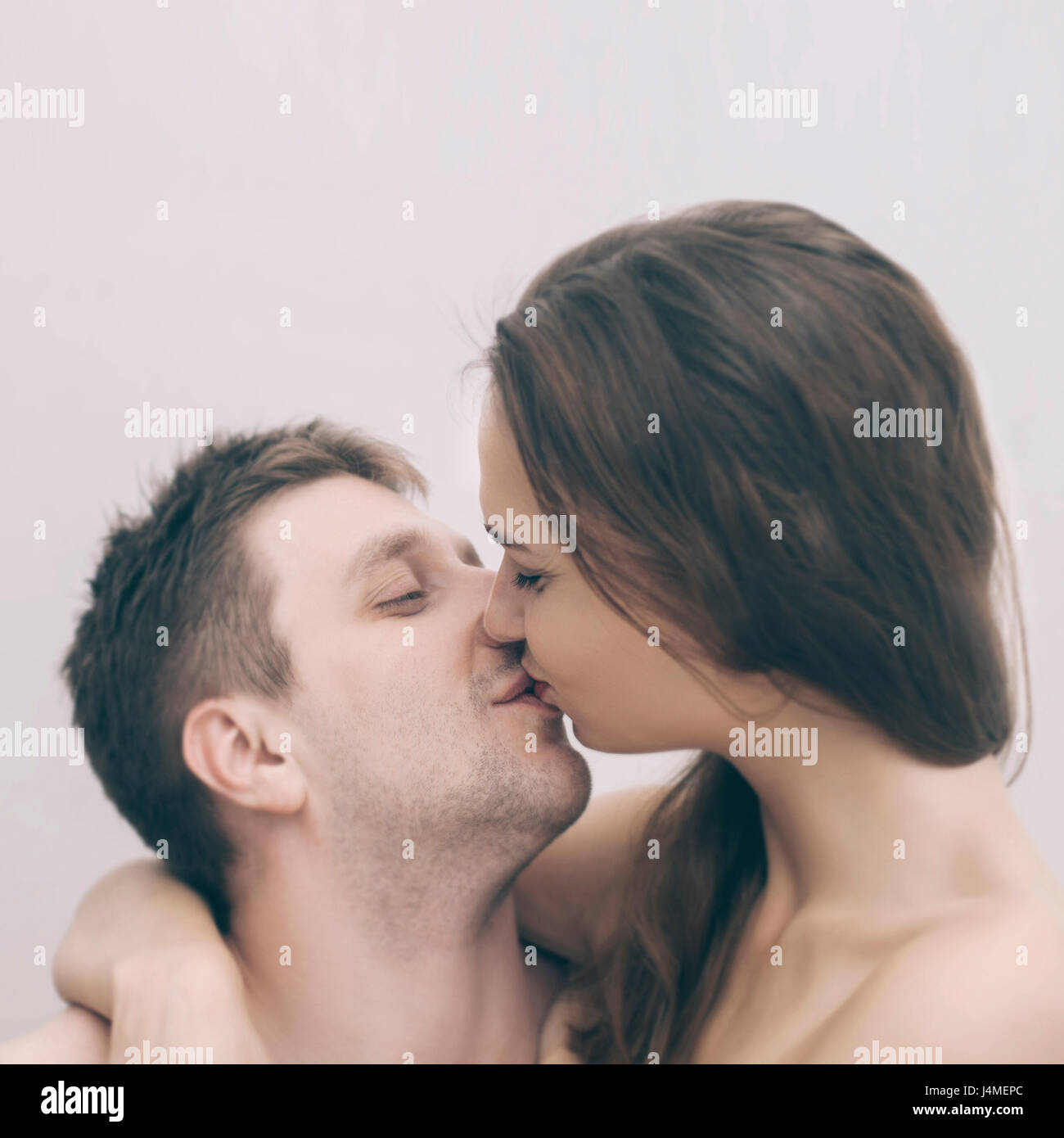 Portrait of kissing Caucasian couple Stock Photo