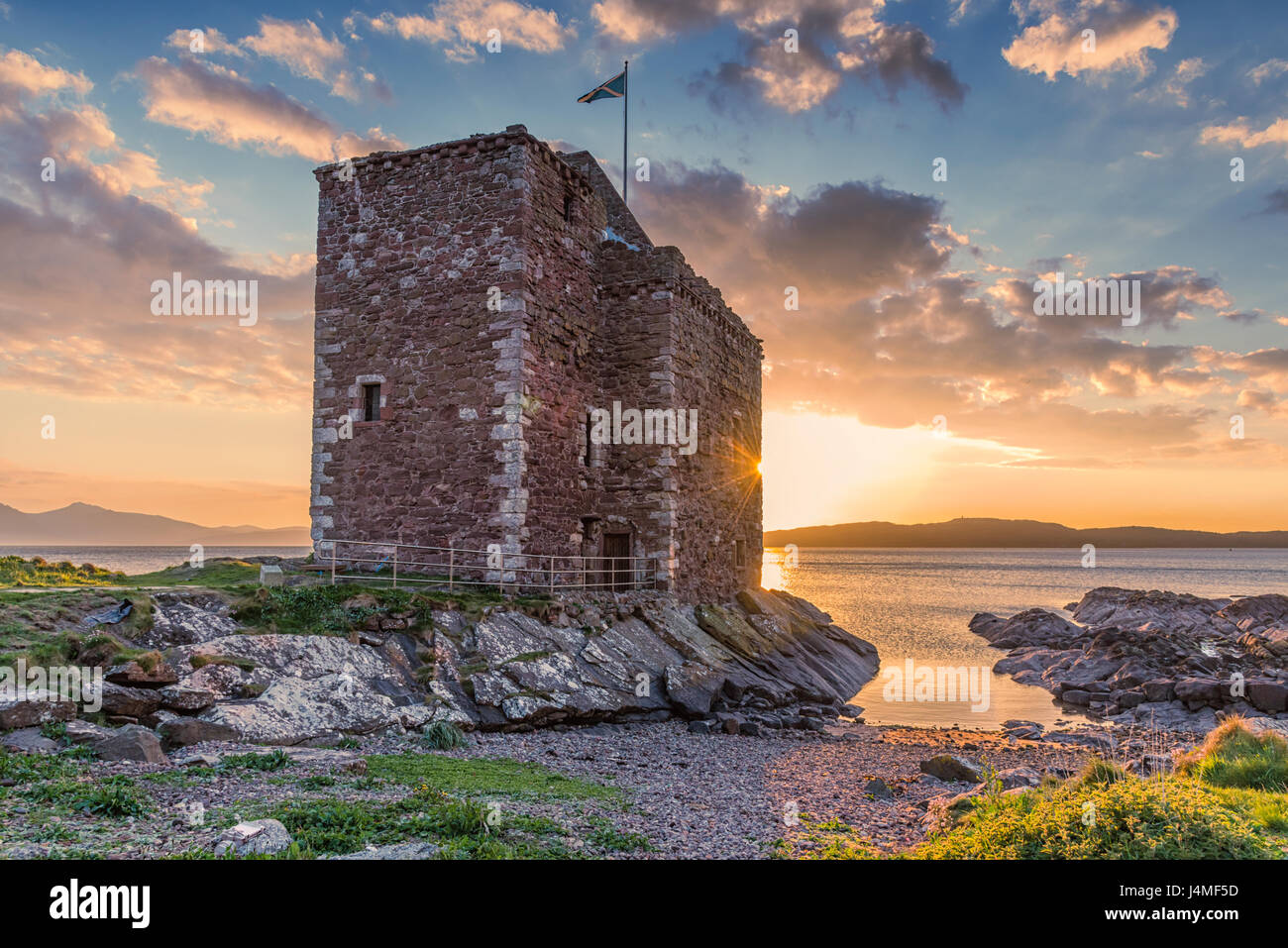 The old Ruin that is Portencross castle at Seamill as the sun went down behind the castle. Stock Photo