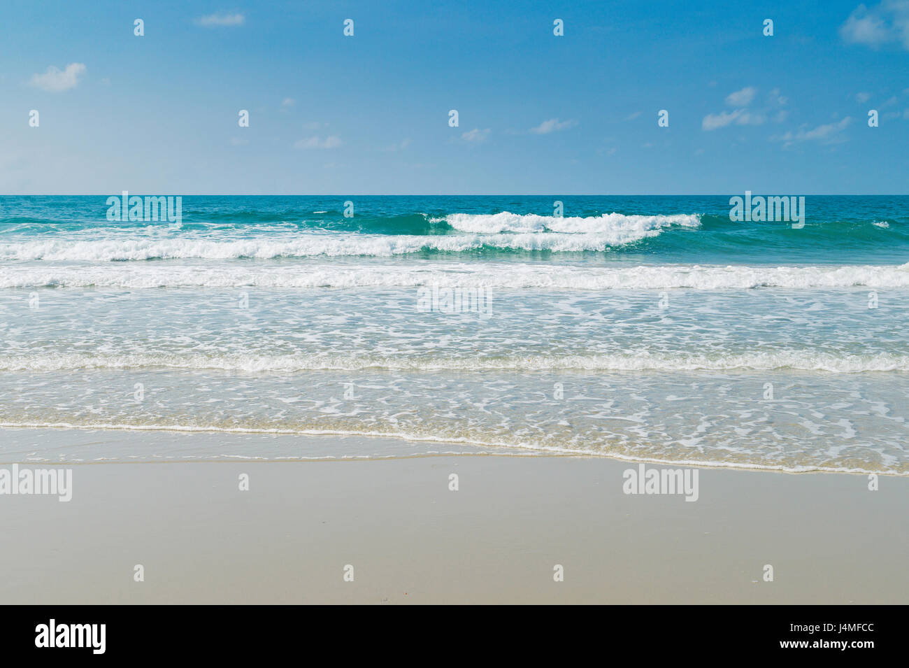 Tropical beach with clear water and blue sky Stock Photo - Alamy