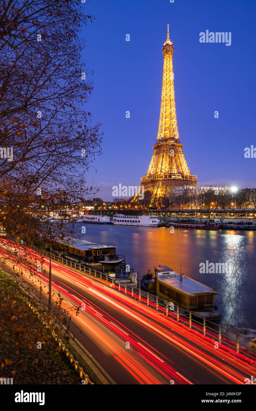 Eiffel Tower illuminated at twilight and Seine River, Paris Stock Photo