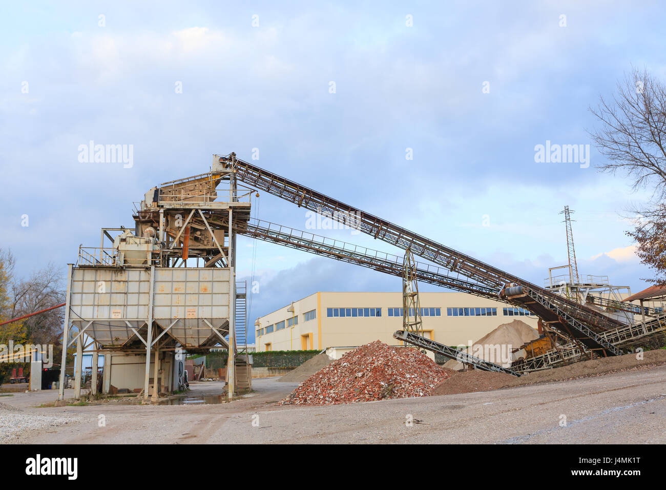 Stone quarry with silos and conveyor belts. Industrial equipment. Mining Stock Photo