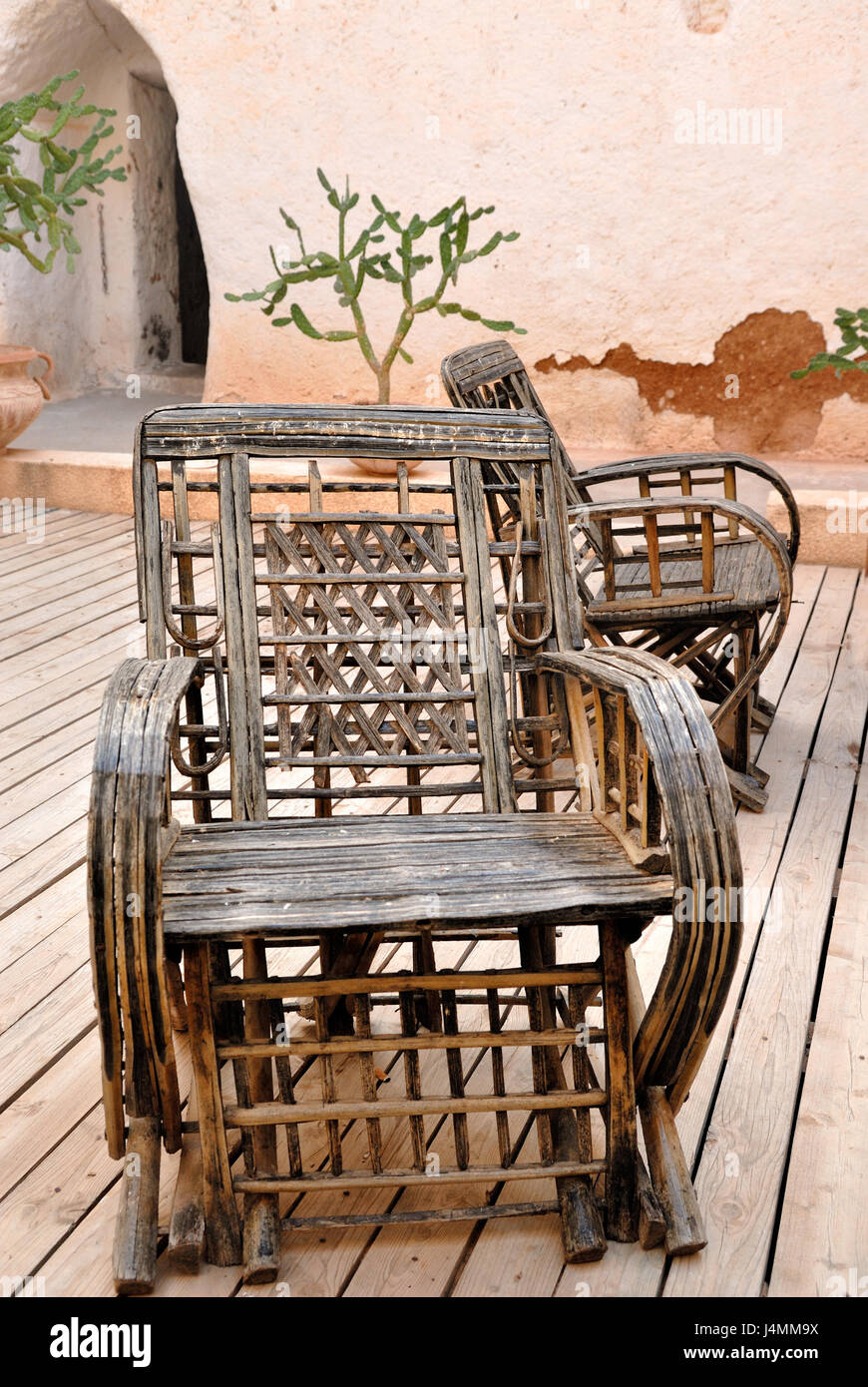 Wicker Armchair With Old Wall Background On Patio In Mexican Style