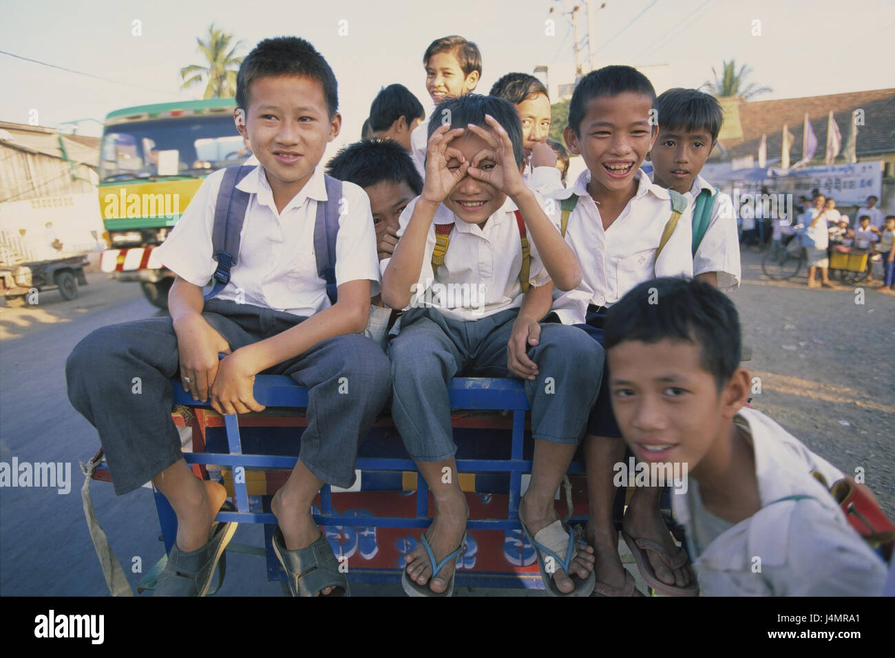 Cambodia, Phnom Penh, street scene, trailer, school children, happily no model release, South-East Asia, capital, school bus, vehicle, transport, promotion, children, boys, unit clothes, fun, laugh, joy Stock Photo