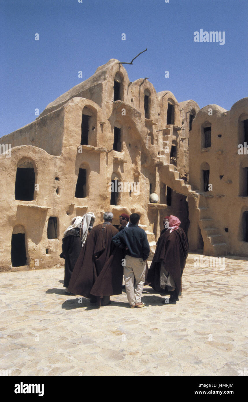 Tunisia, region of Tataouine, Ksar Ouled Soultane, memory castles, bedouins, no model release! Africa, Südtunesien, oasis, building, fortress, castle, Ksar, niches, memories, Ghorfas, granaries, old, architecture, outside, village, structure, tradition, culture, story, destination, place of interest, travelling, people, men Stock Photo