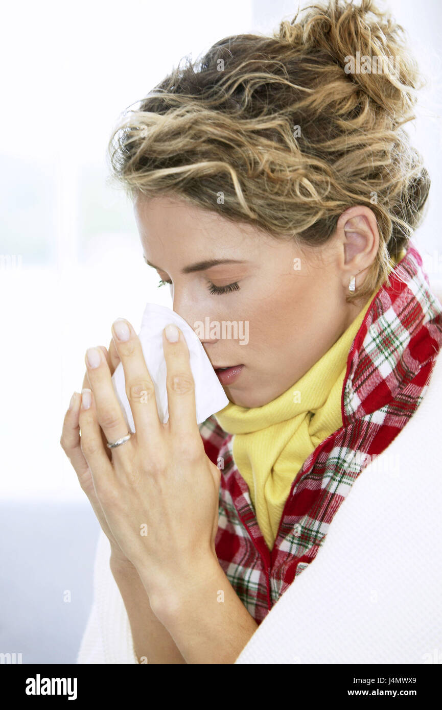 Woman, sneeze young, ill, handkerchief, portrait, at the side , women's portrait, 20-30 years, blond, locks, hairs tied back, sleep suit, ceiling, scarf, cold, disease, grippaler infection, sore throat, coryza, nose to walrus moustaches, inside, at home Stock Photo