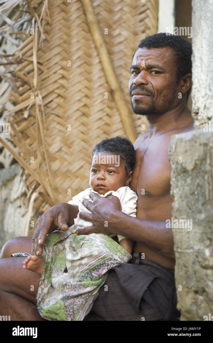 The Comoro Archipelago, island Anjouan, Moya, father, baby, holds, view camera no model release! Africa, Indian ocean, island state, Nzwani, man, parent, upper part of the body freely, swarthy, swarthy, non-white, local, younger generation, child, infant, son, sit, outside, house defensive wall, detail Stock Photo