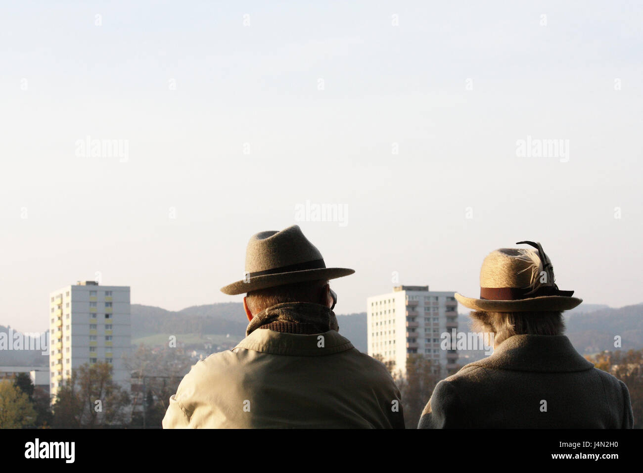 Senior citizen's couple, hats, back view, view, high rises, Stock Photo