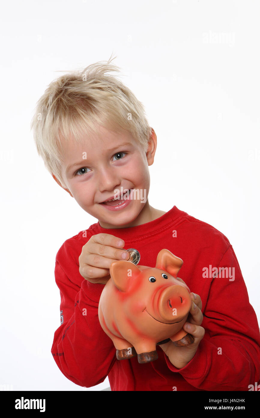 Boy, smile, piggy bank, hold, coin, throw in, half portrait, model released, people, child, blond, happily, joy, save, economy tin, pig, money, euro, euro coin, cash, change, pocket money, savings, studio, Frei's plate, Stock Photo
