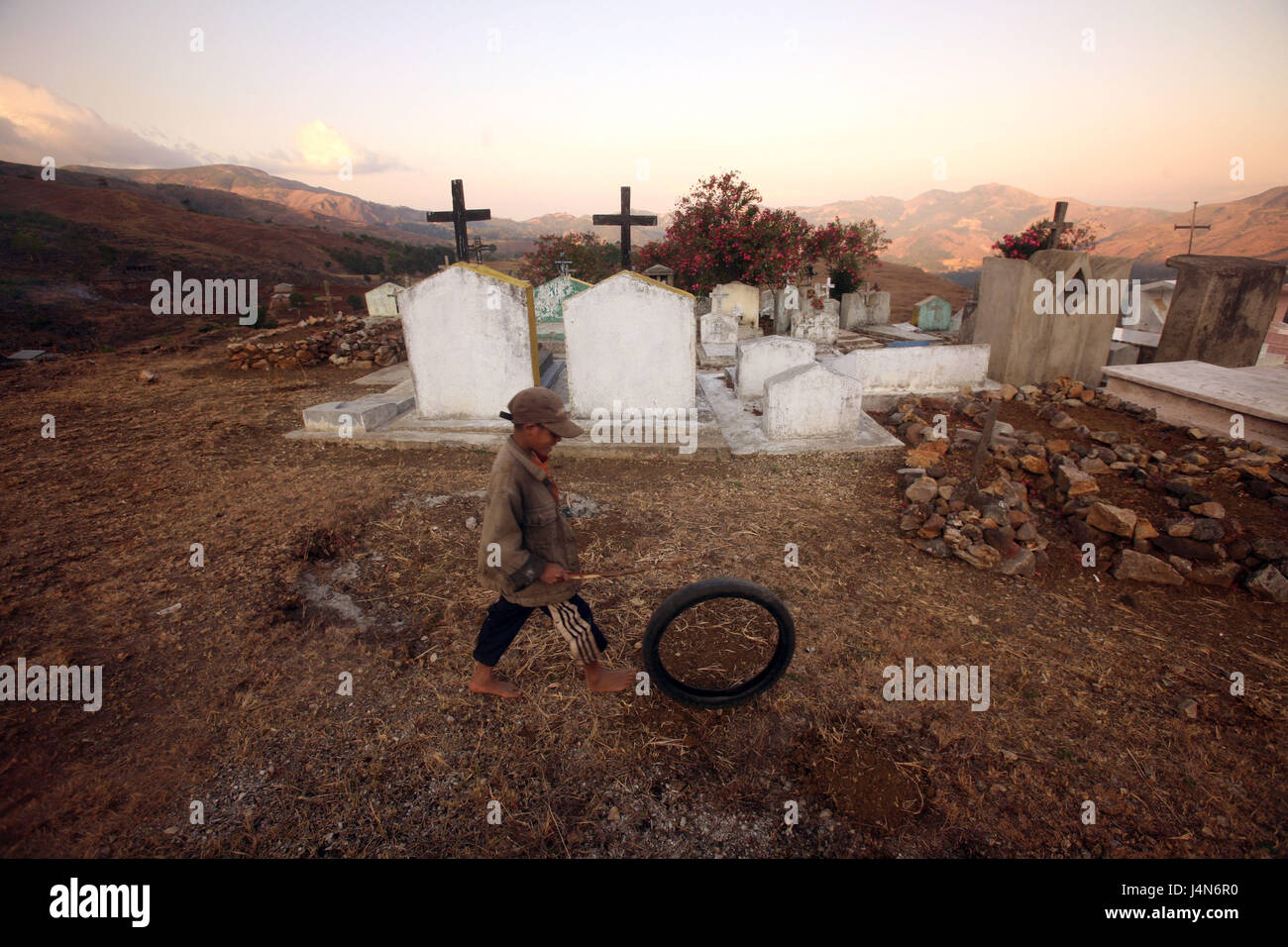 Democratic republic of Timor-Leste, poor bites, mountain region, cemetery, child, play, Stock Photo