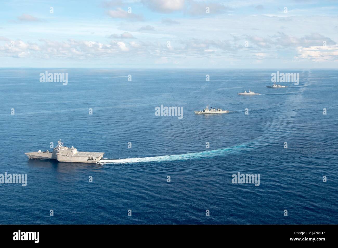 The U.S. Navy littoral combat ship USS Coronado, Republic of Singapore Navy frigate RSS Intrepid, Arleigh Burke-class guided-missile destroyer USS Sterett and the Royal Thai Navy frigate HTMS Naresuan during divisional tactics as part of the multilateral Cooperation Afloat Readiness and Training May 11, 2017 in the South China Sea. Stock Photo