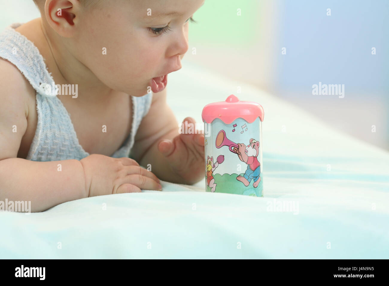 Baby, 6 months, Rassel, play, tread, curled, Stock Photo