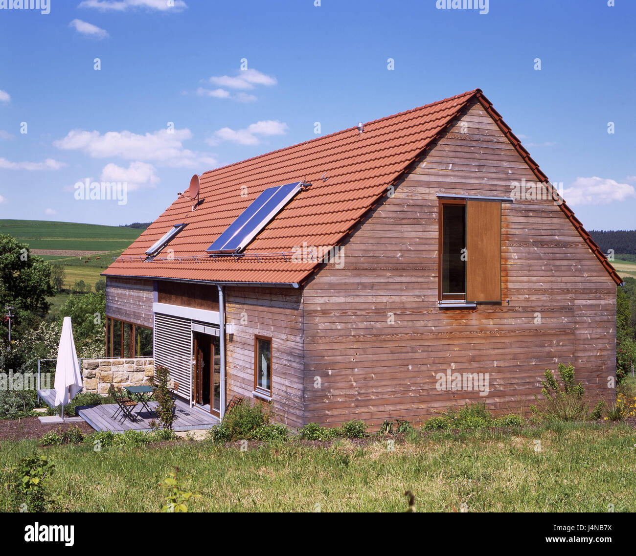 Hill scenery, single-family dwelling, scenery, house, residential house, summer cottage, wooden house, wooden facade, rurally, garden, terrace, roof, house roof, gable roof, solar attachment, architecture, living, creation, own home, real estate, design, hillside situation, environment, seclusion, rest, Idyll, Stock Photo