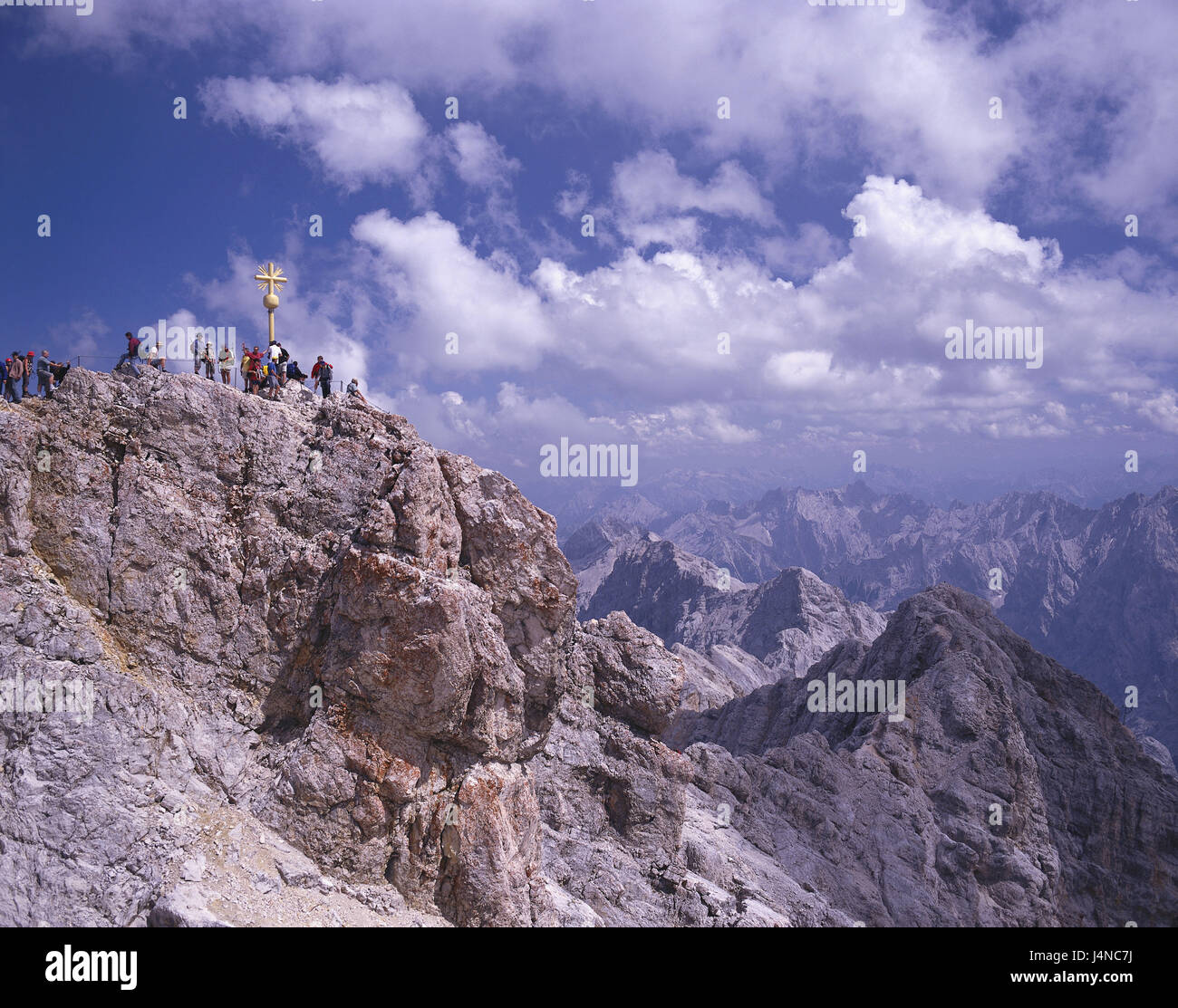 Germany, Bavaria, Zugspitze, east summits, summit cross, visitor, Upper Bavaria, alps, Wetterstein Range, Zugspitze summit, summit, cross, golden, mountain, mountaintop, lookout, mountains, mountain panorama, scenery, mountain landscape, place of interest, tourism, person, mountaineer, tourist, view, , width, distance, outside, summer, cloudy sky, Stock Photo