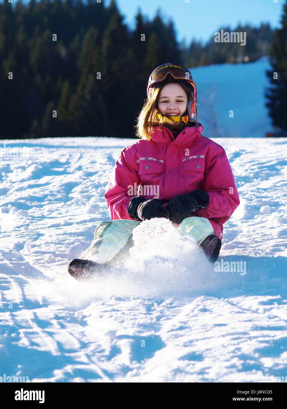 Child, girl, happily, slip, play snow, winter, leisure time, winter holidays, winter vacation, person, helmet, ski helmet, motion, happily, winter clothes, fun, romp, rave, melted, winter joys, toboggan, winter scenery, scenery, Stock Photo