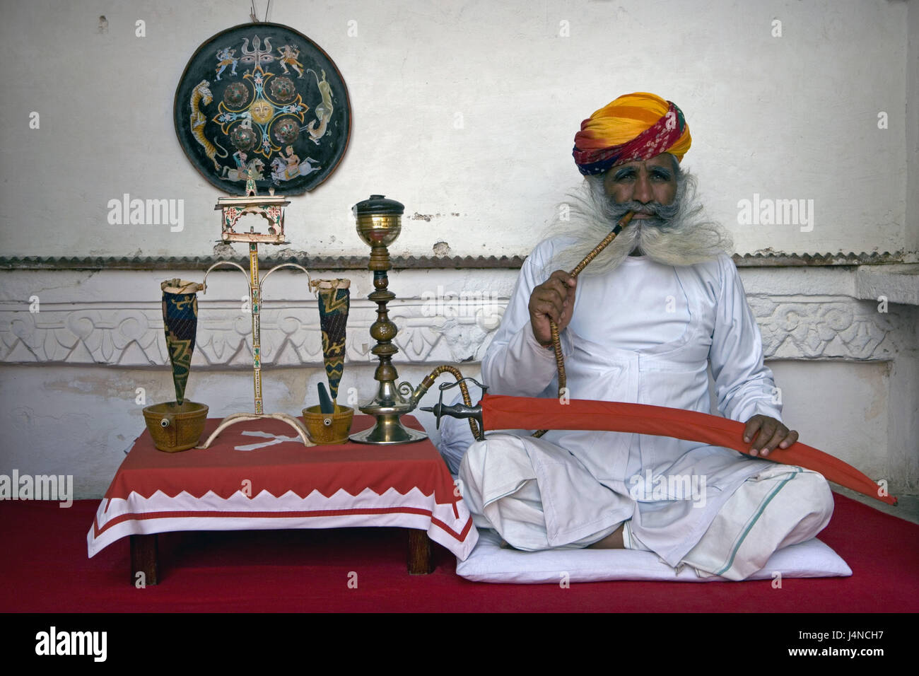 India, Rajasthan, Jodhpur, Meherangarh fort, man, water whistle, smoke, Stock Photo